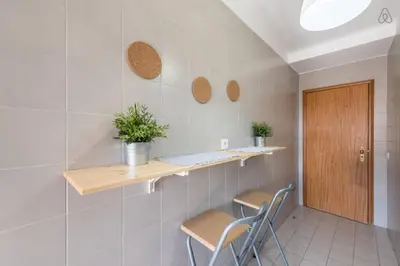 a room with two chairs and a table and a door at Gaia House - Apartamento com Metro à Porta e Centro Histórico Perto in Vila Nova de Gaia