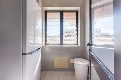 a white bathroom with a window and a toilet at Gaia House - Apartamento com Metro à Porta e Centro Histórico Perto in Vila Nova de Gaia