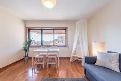 a living room with a table and a couch at Gaia House - Apartamento com Metro à Porta e Centro Histórico Perto in Vila Nova de Gaia