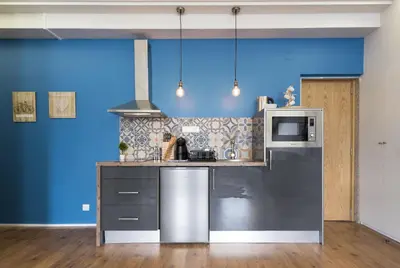 a kitchen with a stainless steel refrigerator and a microwave at Sta Catarina - 2 Bedroom Apartament in Porto