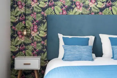 a bedroom with a bed with a floral wallpaper at Sta Catarina - 2 Bedroom Apartament in Porto