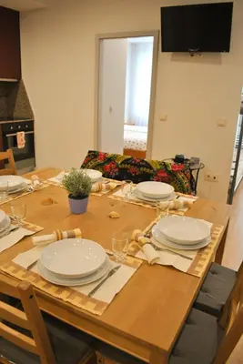 a wooden table with plates on top of it at Apartamentos Portodouro - Santa Catarina in Porto