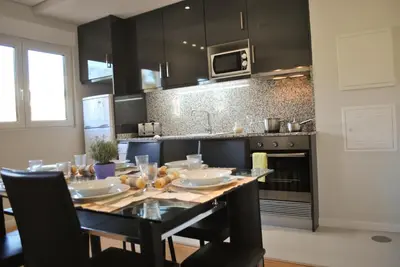 a kitchen with a table with plates and bowls on it at Apartamentos Portodouro - Santa Catarina in Porto
