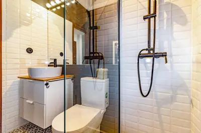 a bathroom with a toilet and a glass shower at Camões Loft in Porto