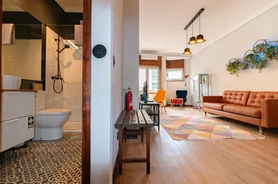 a living room with a couch and a table at Camões Loft in Porto