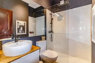 a bathroom with a sink and a toilet and a shower at Camões Loft in Porto