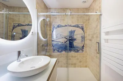 a bathroom with a sink and a shower at Casa das Musas 2 in Porto