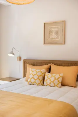 a bedroom with a bed with pillows and a lamp at Casa das Musas 2 in Porto