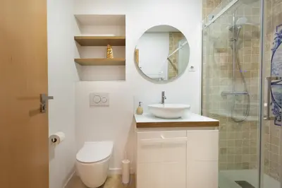 a bathroom with a toilet and a sink and a shower at Casa das Musas 2 in Porto