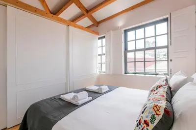 a white room with a bed and a window at Newly Renovated Cozy Central Loft w/ AC by LovelyStay in Porto