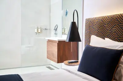 a bathroom with a sink and a bed and a mirror at Rio da Vila in Porto