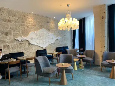 a restaurant with tables and chairs and a chandelier at Rio da Vila in Porto