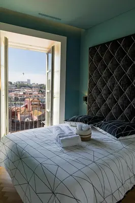a bedroom with a large bed with a large window at Infante Douro View in Porto