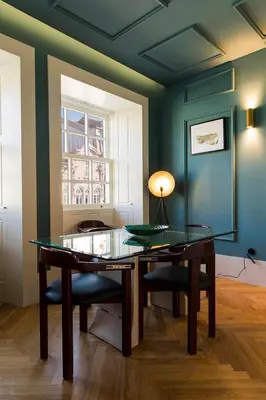 a dining room with a glass table and a window at Infante Douro View in Porto
