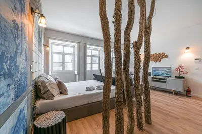a bedroom with a bed with trees in it at GuestReady - Nature-themed Studio in Porto