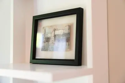 a picture frame on a shelf in a white wall at Casa Nina in Porto