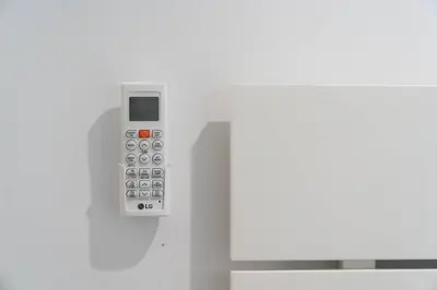 a remote control is attached to a white wall at Joy Porto in Porto