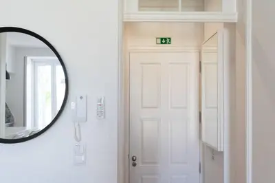 a mirror and a door with a clock on it at Joy Porto in Porto