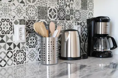 a kitchen counter with two utensils and a coffee maker at Joy Porto in Porto
