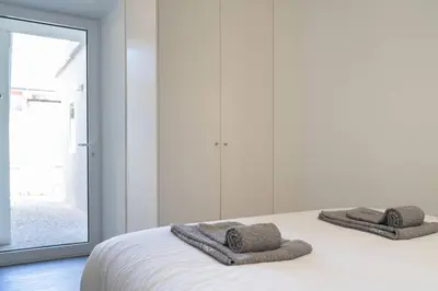 a bedroom with a bed with two towels on it at Joy Porto in Porto
