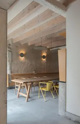 a dining room with a wooden table and chairs at Na Travessa Suítes in Porto
