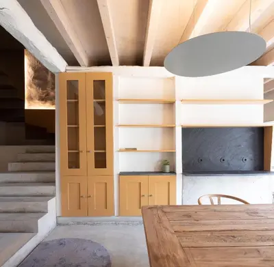 a dining room with a table and a vaulted ceiling at Na Travessa Suítes in Porto