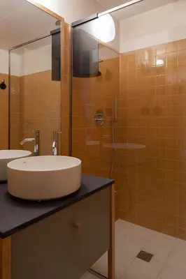 a bathroom with a sink and a shower at Na Travessa Suítes in Porto