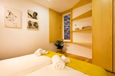 a bedroom with a bed with towels on it at Miragaia Rio in Porto
