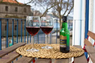 two glasses of red wine sitting on a picnic table at Miragaia Rio in Porto