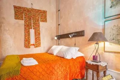 a bedroom with a bed with an orange blanket at VIVA Fabulous Old World in Porto
