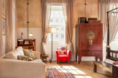 a living room with a couch and a chair and a window at VIVA Fabulous Old World in Porto