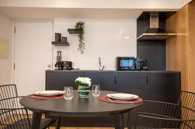 a dining room table with two plates and glasses at Lemago Porto Apartments - Poveiros in Porto