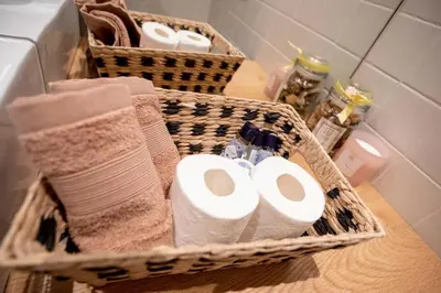 two baskets with toilet paper and towels on a counter at Lemago Porto Apartments - Poveiros in Porto