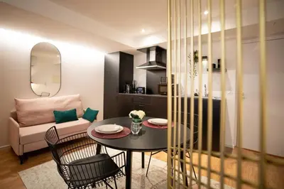 a living room with a table and chairs and a couch at Lemago Porto Apartments - Poveiros in Porto