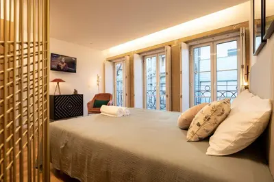 a bedroom with a large bed with two pillows at Lemago Porto Apartments - Poveiros in Porto