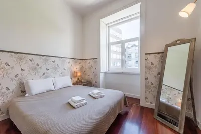 a bedroom with a bed with two towels on it at GuestReady - Cityscape coastal flat in Porto