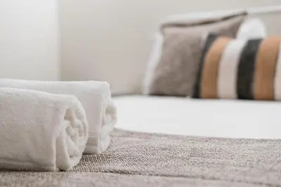 a close up of a bed with towels on it at GuestReady - Bourse Apartments in Porto
