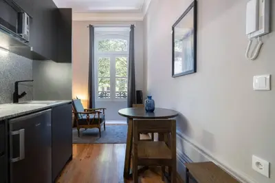 a kitchen with a table in the middle of a room at Oporto Sao Lazaro Apartment in Porto