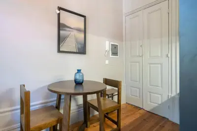 a dining room with a table and chairs and a mirror at Oporto Sao Lazaro Apartment in Porto