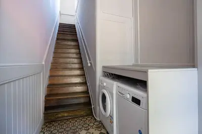 a hallway with a washer and dryer in a house at Oporto Sao Lazaro Apartment in Porto