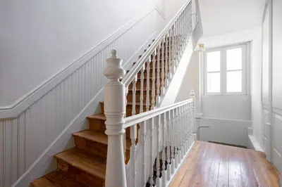 a staircase with white railings and wood floors at Oporto Sao Lazaro Apartment in Porto