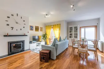 a living room with a couch and a fireplace at GuestReady - Candal Big Watch in Vila Nova de Gaia