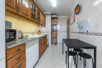 a kitchen with a black table and two stools at GuestReady - Candal Big Watch in Vila Nova de Gaia