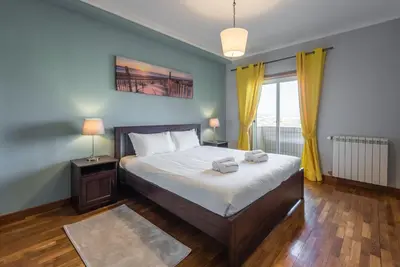a bedroom with a bed with two towels on it at GuestReady - Candal Big Watch in Vila Nova de Gaia