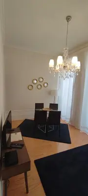 a living room with a table and a chandelier at ML Apartments Almada Living in Porto