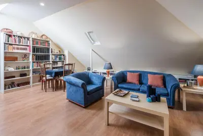 a living room with a blue couch and a table at GuestReady - Urban escape in Porto in Porto