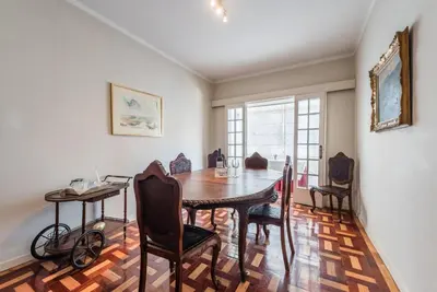 a dining room with a wooden table and chairs at GuestReady - Urban escape in Porto in Porto