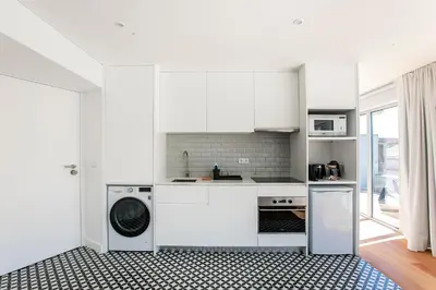 a kitchen with white cabinets and a dishwasher at Luminous Premium Loft w/AC & Terrace by LovelyStay in Porto