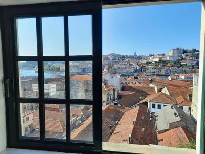a view of a city from an open window at MyRiverPlace N 5 River View Porto apartments in Vila Nova de Gaia