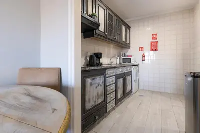 a kitchen with a counter and a table in it at MyRiverPlace N 5 River View Porto apartments in Vila Nova de Gaia